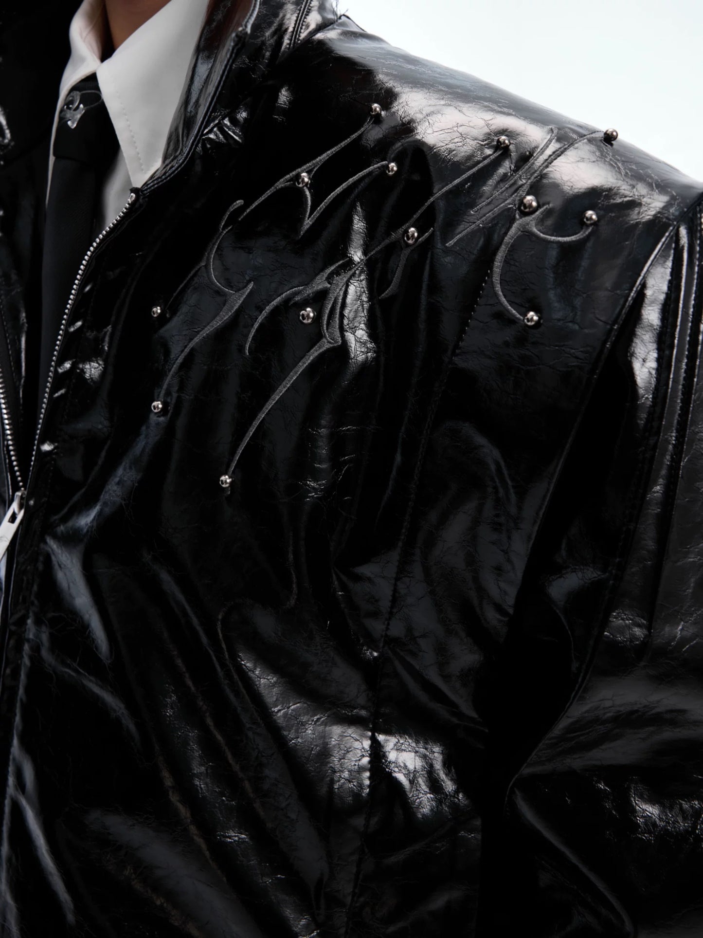 Deceptive eye spine rivet shiny leather jacket